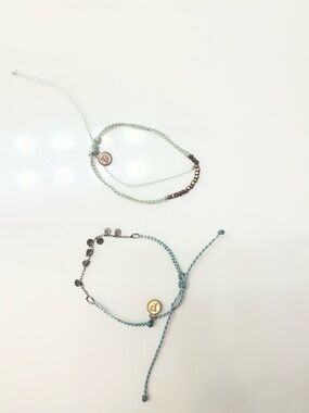Two puravida bracelets have some discoloration but mostly in good condition.